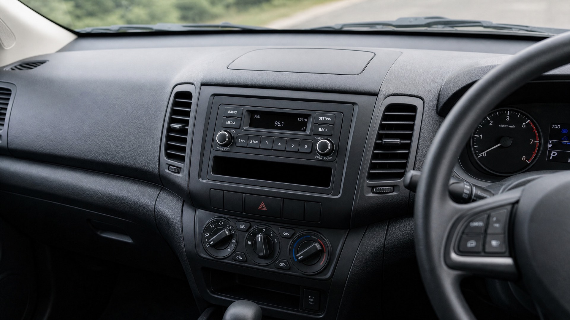 A dash from the driver’s seat — factory radio and blank fascia before the retrofit